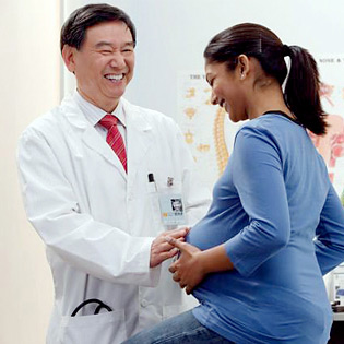 Mother getting screened by doctor